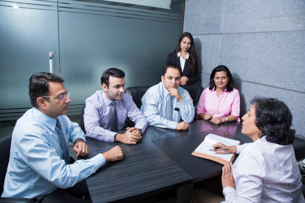 Professionals having an English conversation in a workplace meeting