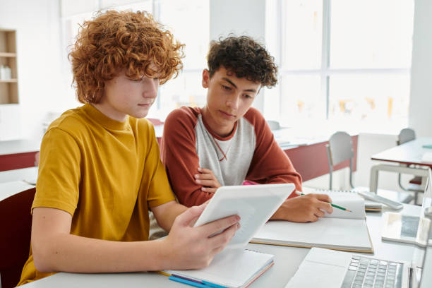 Two students practising English conversation in a classroom