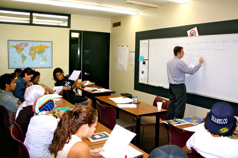 Students learning spoken English and grammar in a classroom
