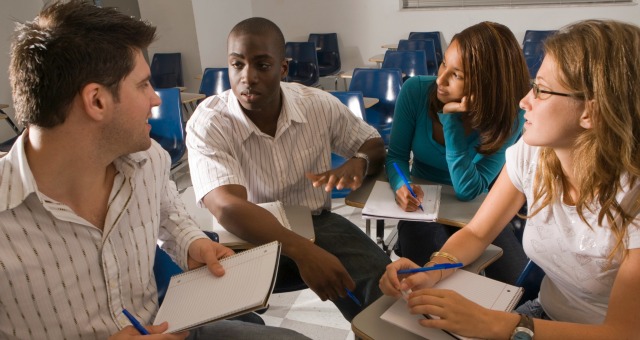 Students practicing English conversation in a classroom