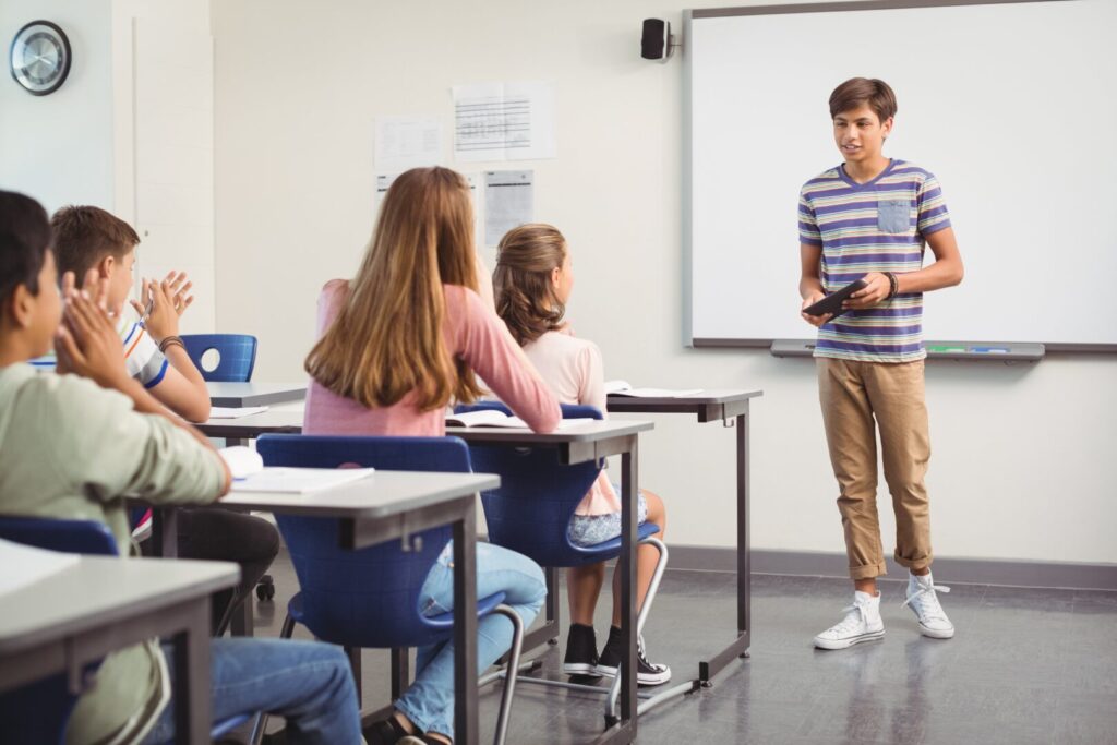 English learner practicing spoken English confidently in a classroom
